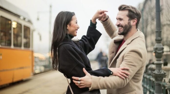 happy couple dancing around with each other.