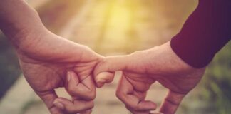 header best ted talks on relationships: image of couple linking pinky fingers with a sunset background