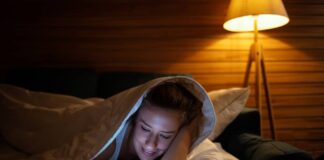 Woman in bed with blanket as she reads good night messages for her