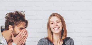 Couple laughing as they ask fun Would You Rather Questions for Couples