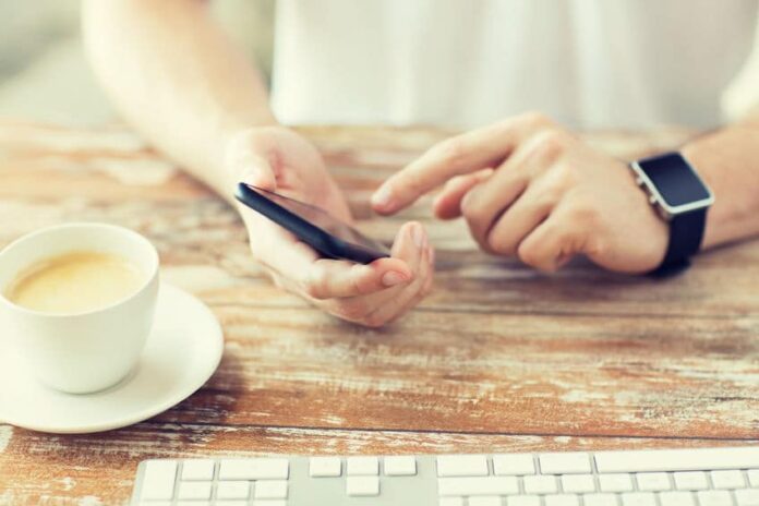 texting while having a cup of coffee