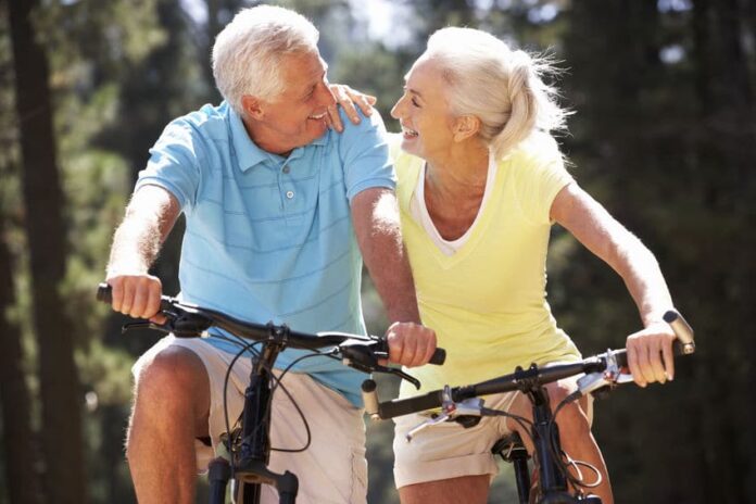 happy matured couple biking