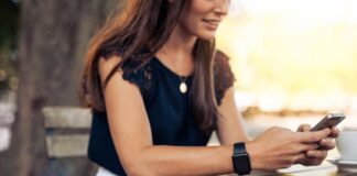 Woman using mobile phone at cafe