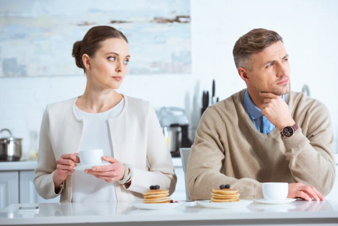 gorgeous woman looking at her gorgeous man who is thinking