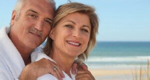 Senior couple wearing white at the beach