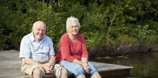 old couple sitting and having a great time in the lake