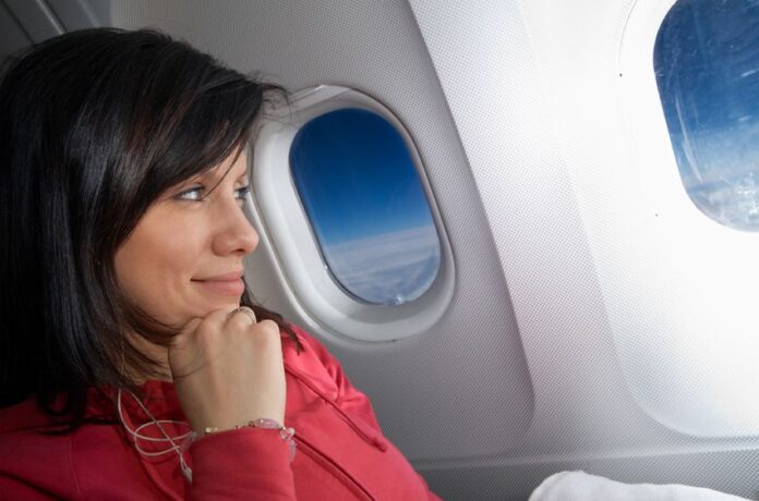 black haired woman wearing pink sleeves watching the clouds