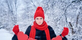 Woman holding paper crafted hearts thinking of what to do on valentines day