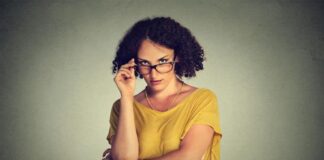 feminist woman wearing eyeglasses and yellow dress