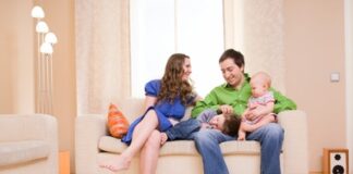 Happy young family of four enjoying time at their home