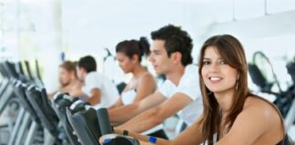 Group of gym people exercising on cardio machines