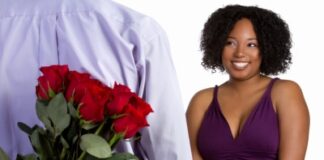 man bringing red roses and courting a black beautiful woman