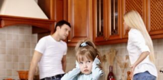 young couple fighting in front of their kid