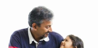 Asian Indian father having conversation with her daughter over white background