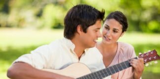 Man playing a guitar to his girlfriend