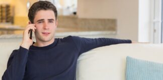 Man sitting on the sofa and calling in living room