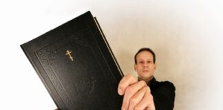 a religious man holding a bible