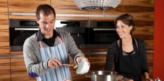 husband and wife cooking together in the kitchen