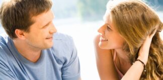 a young couple looking at each other while smiling