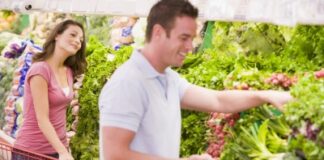 young woman looking at a man buying products at the produce section