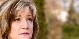 A pretty middle aged woman looking upwards.