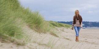 woman walking alone along a deserted beach