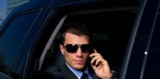 a business man on his phone riding a black car