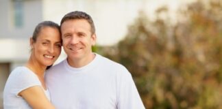 Smiling mature couple standing together outdoors