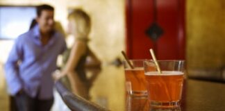 man and woman talking at the bar