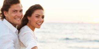 young couple at the beach during sunset