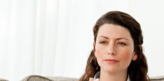 woman deeply thinking while drinking coffee