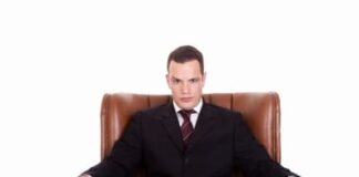 businessman sitting on a chair, looking seriously