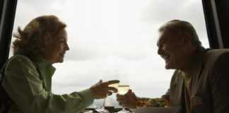 mature couple at a restaurant drinking wine and laughing