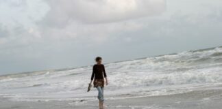 woman walking on the shore, alone