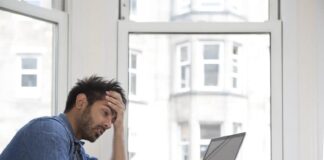 a frustrated guy staring at his laptop