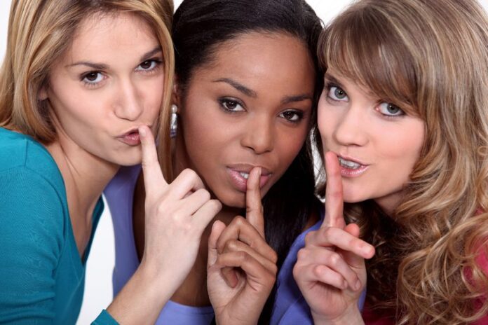 three attractive woman giving a quiet sign