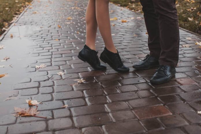 A pair of feet belong to a couple on rainy day date ideas