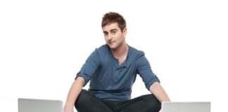 young man in between two laptops