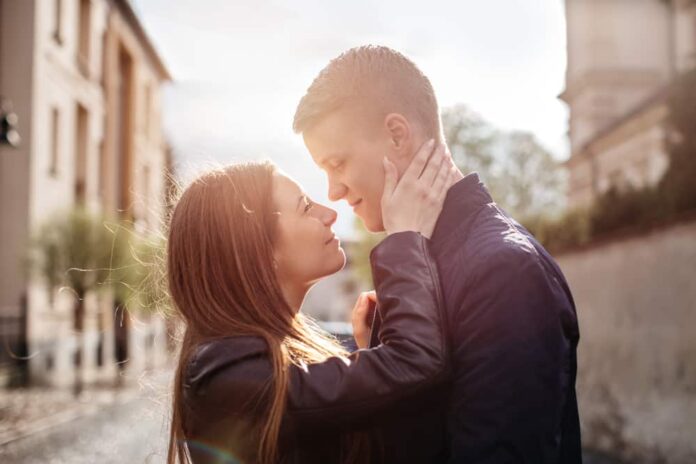 relationship advice for couples header - A young couple in love hugging and kissing in the city