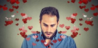 surprised young man finding love with his mobile phone
