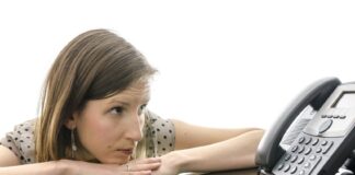 woman looking intently at the telephone