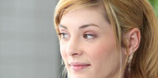 young blonde woman looking at her side