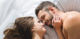 A couple snuggles together enjoying the benefits of cuddling