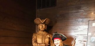 A child poses with a pirate actor while enjoying things to do in Savannah with kids