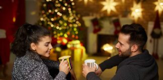 Christmas couple at home exchanging Christmas gifts for married couples