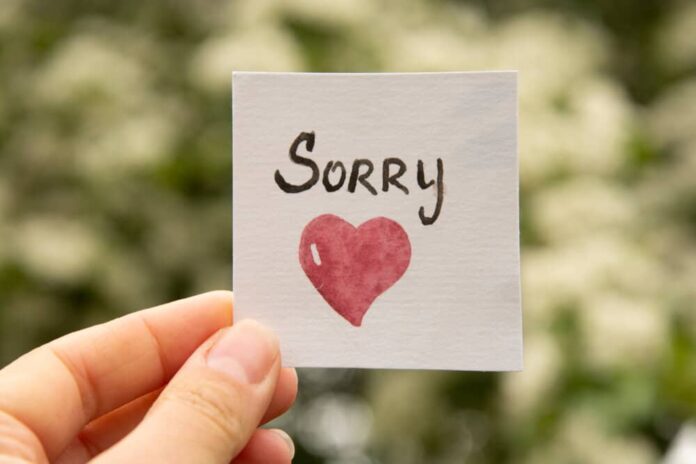 A sorry sticker with a heart is held in sorry messages for her