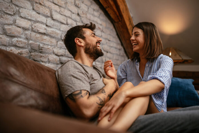 board games for couples header image - Cropped shot of a young happy couple relaxing at home