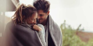 when you meet the right person header image - photo of cute couple wrapped up together in gray blanket. standing outside on cloudy day