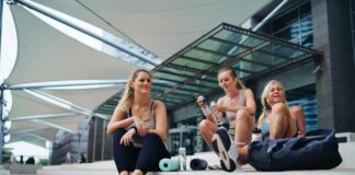 three woman in sports wear preparing for a workout