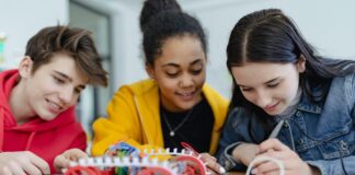 three students working on robotics